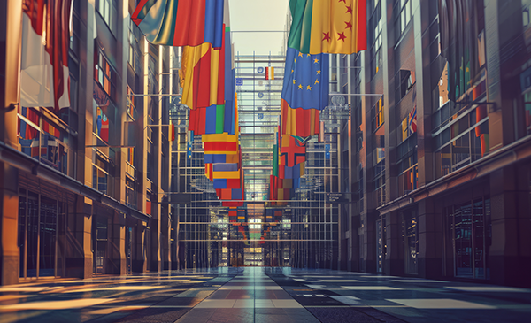 An atrium with glass partitions. International flags are hanging from the ceiling.